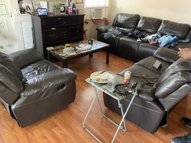 living room with wood-type flooring and cooling unit