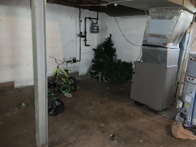 basement featuring heating unit and water heater