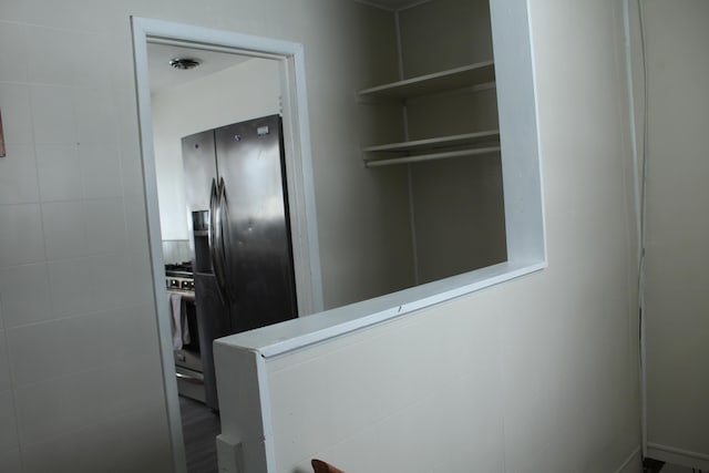 interior space with stainless steel fridge with ice dispenser