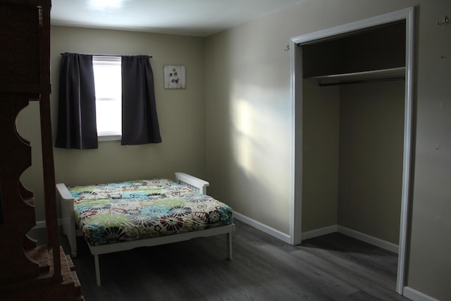 bedroom featuring a closet and dark hardwood / wood-style flooring