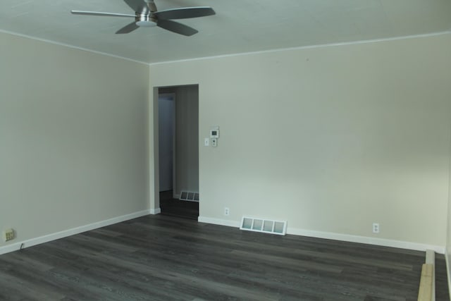 empty room featuring ceiling fan, crown molding, and dark hardwood / wood-style floors