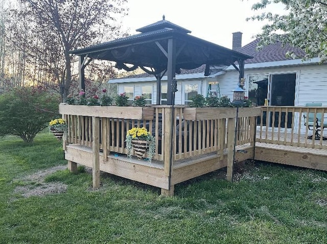 wooden terrace featuring a yard