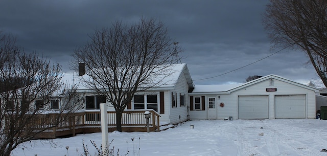 single story home with a garage and a wooden deck