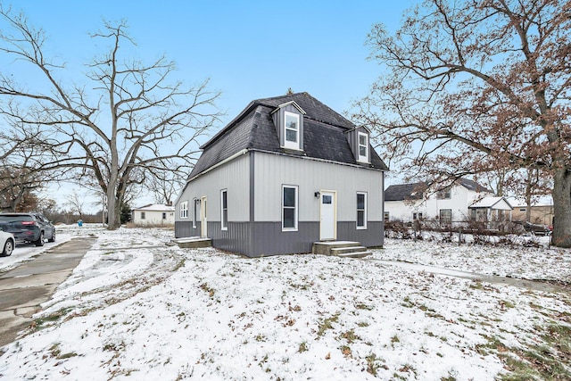 view of snow covered rear of property