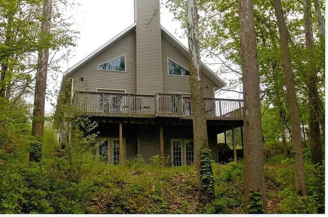 rear view of property featuring a deck