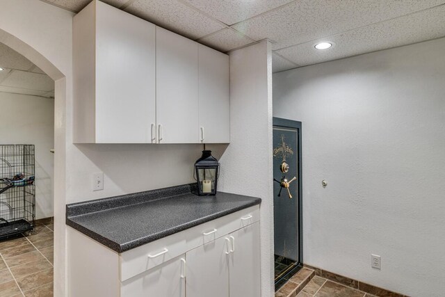 kitchen with white cabinets and a paneled ceiling