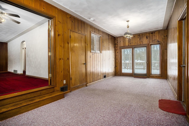 empty room featuring ceiling fan and carpet floors