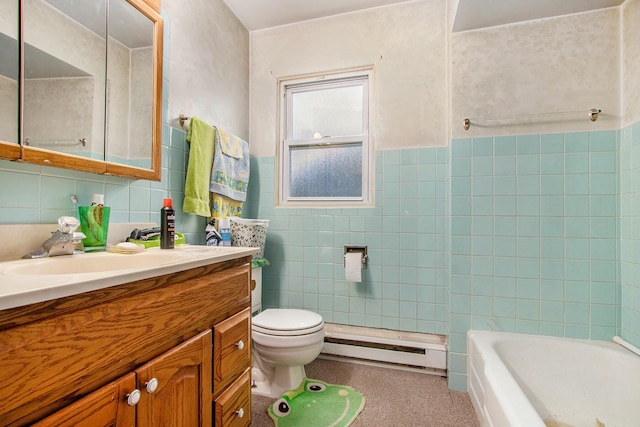 bathroom featuring a washtub, vanity, tile walls, and a baseboard heating unit