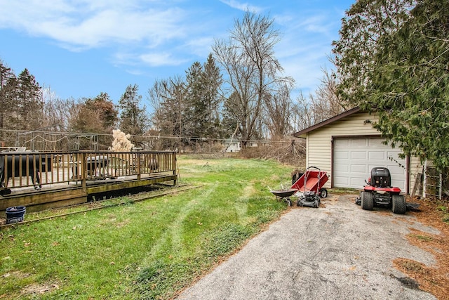 view of yard with an outbuilding, a garage, and a deck