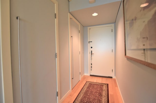 doorway to outside with light wood-type flooring