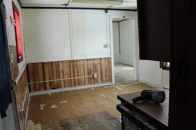 interior space featuring parquet flooring and wood walls