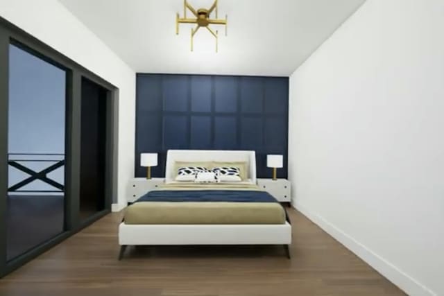 bedroom with hardwood / wood-style flooring and a notable chandelier