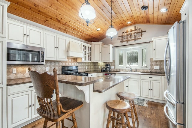 kitchen with premium range hood, a breakfast bar, vaulted ceiling, wooden ceiling, and stainless steel appliances