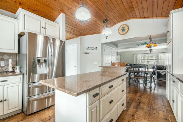 kitchen featuring pendant lighting, dark stone countertops, backsplash, wood ceiling, and stainless steel refrigerator with ice dispenser