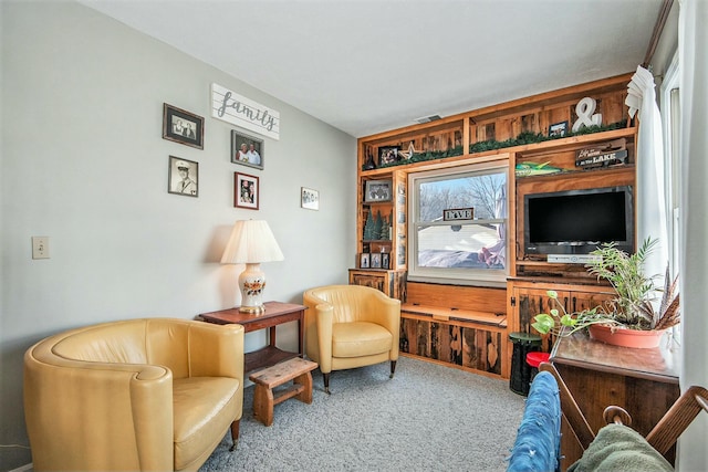 living area with carpet floors and built in features