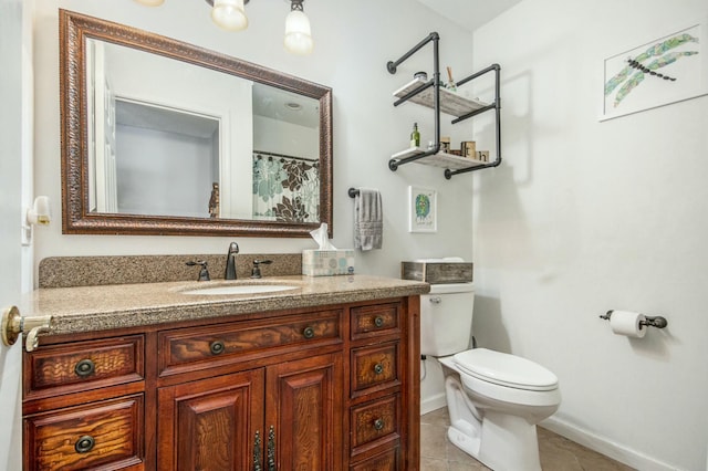 bathroom with vanity, tile patterned floors, and toilet