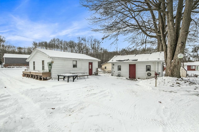 view of snow covered rear of property