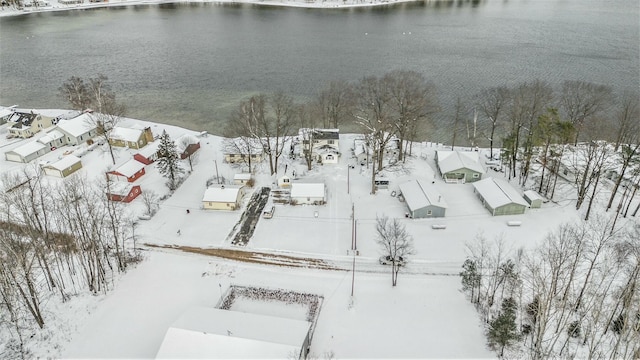 snowy aerial view featuring a water view