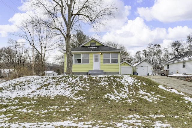 view of front of house with a garage and an outdoor structure