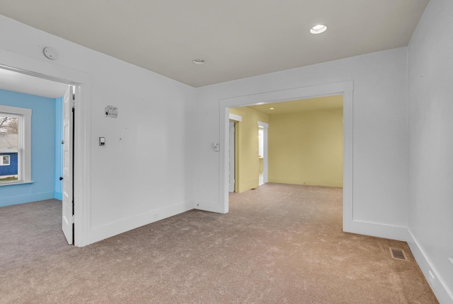 unfurnished room with light colored carpet