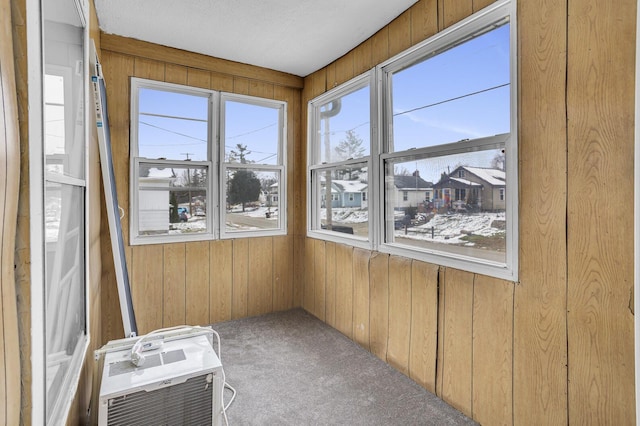 unfurnished sunroom featuring a wall mounted AC