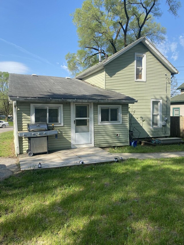 back of property featuring a lawn