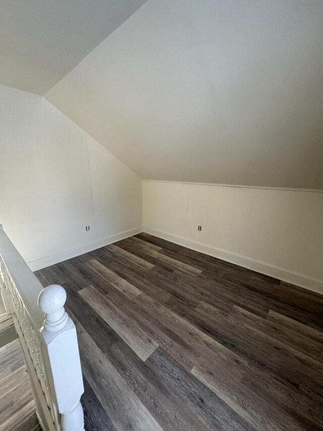 bonus room featuring dark wood-type flooring and lofted ceiling