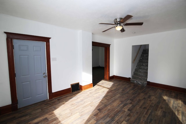 unfurnished room featuring ceiling fan and dark wood-type flooring