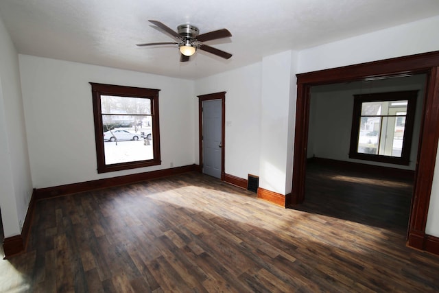 spare room with ceiling fan and dark hardwood / wood-style floors