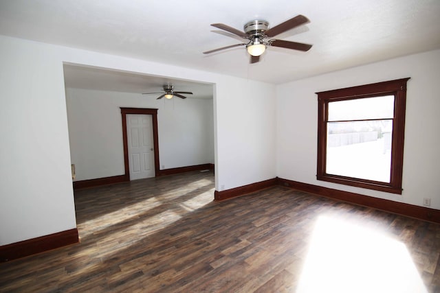 empty room featuring ceiling fan and dark wood-type flooring