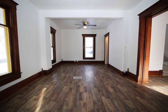 unfurnished room featuring ceiling fan and dark wood-type flooring