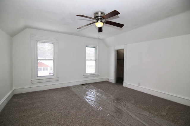 additional living space featuring ceiling fan, carpet floors, and vaulted ceiling