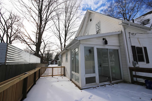 exterior space with a wooden deck and a sunroom