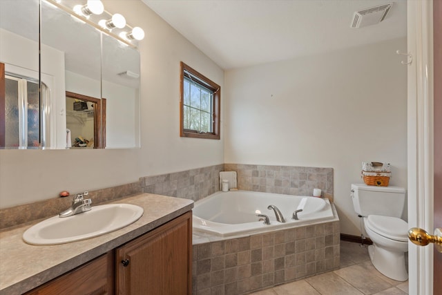 bathroom featuring tile patterned flooring, a relaxing tiled tub, toilet, and vanity