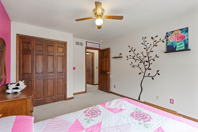 bedroom with ceiling fan, light colored carpet, and a closet