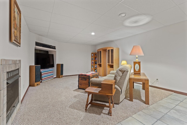 carpeted living room with a drop ceiling