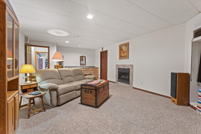 living room with carpet floors, sink, and a tile fireplace