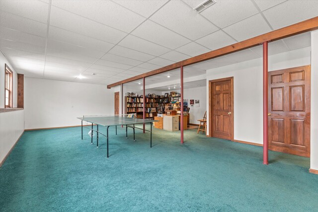 recreation room with a paneled ceiling and carpet floors