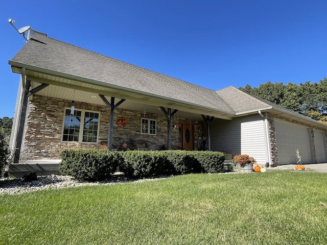 single story home featuring a porch, a garage, and a front yard