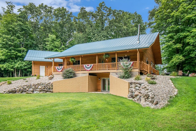 rear view of property featuring a yard