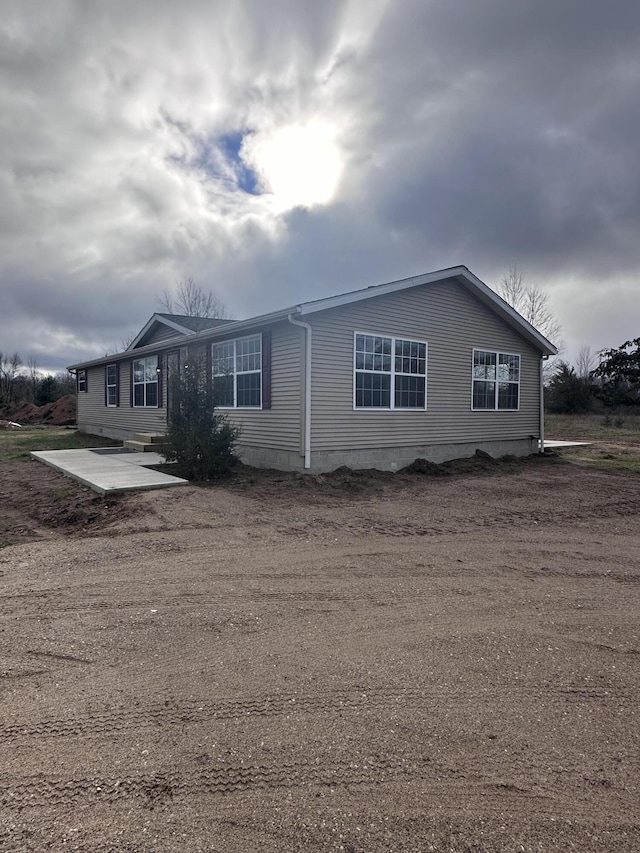 view of property exterior with a patio area