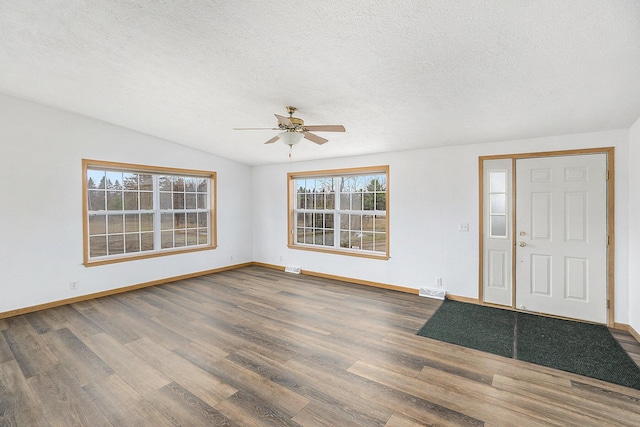 foyer entrance with vaulted ceiling, ceiling fan, wood-type flooring, and a textured ceiling