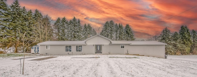 view of front of house featuring a storage shed