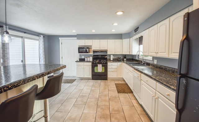 kitchen featuring sink, black appliances, white cabinetry, hanging light fixtures, and light tile patterned flooring