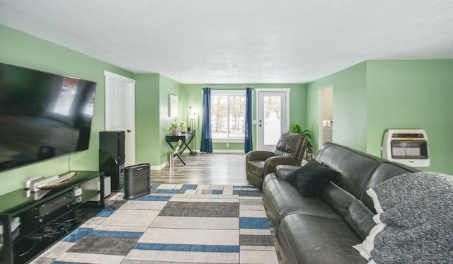 living room featuring light wood-type flooring and heating unit