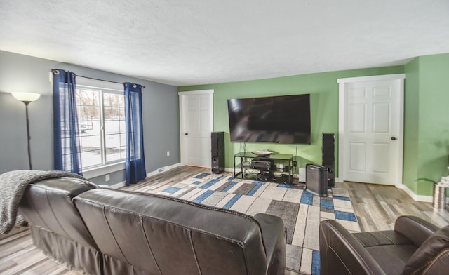 living room with a textured ceiling and light wood-type flooring