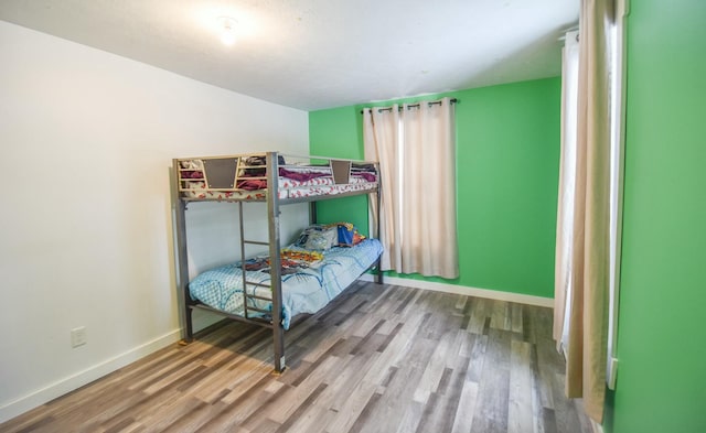 bedroom with hardwood / wood-style flooring