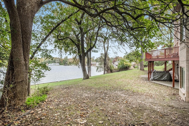 view of yard with a patio area and a deck with water view