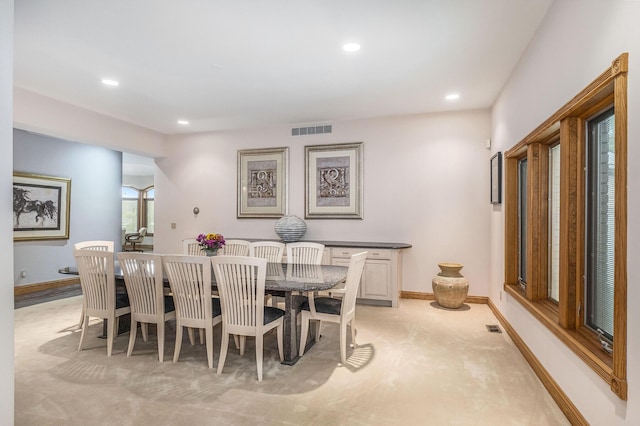 dining room featuring light carpet