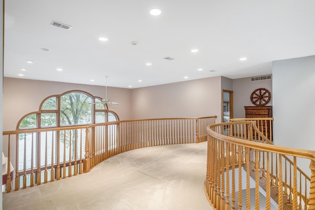 hallway with light colored carpet